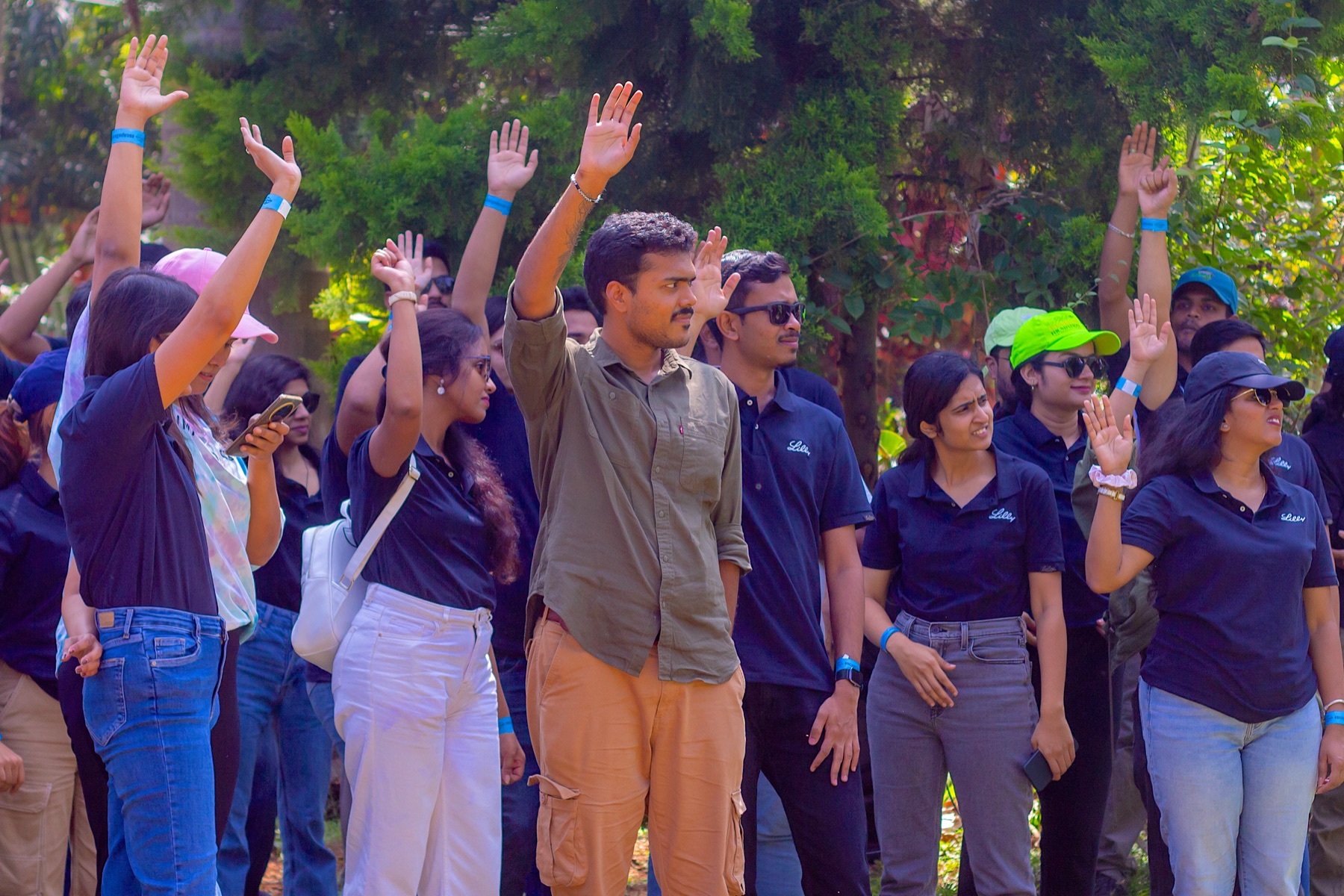 A large group raising hands during a session
