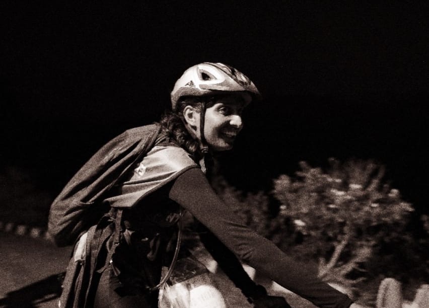 A Team Shershah racer cycling through the night during an Asia Series race
