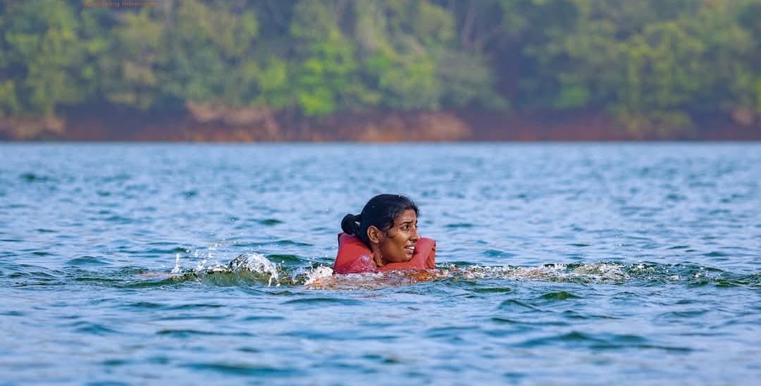 A racer swimming across a lake